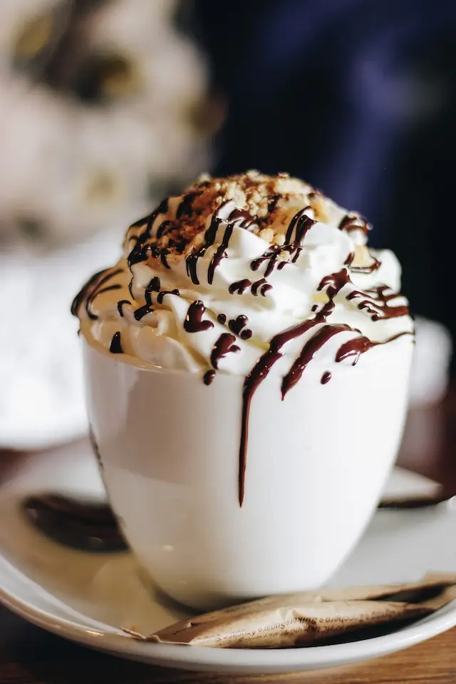 Iced coffee topped with cream and chocolate